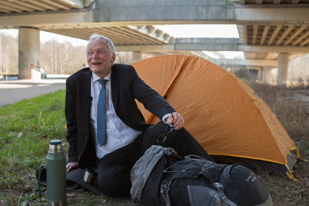 Actor Christian Halken camps by the highway to present Denmark's protected nature for the Greenpeace campaign Tourism Denmark.